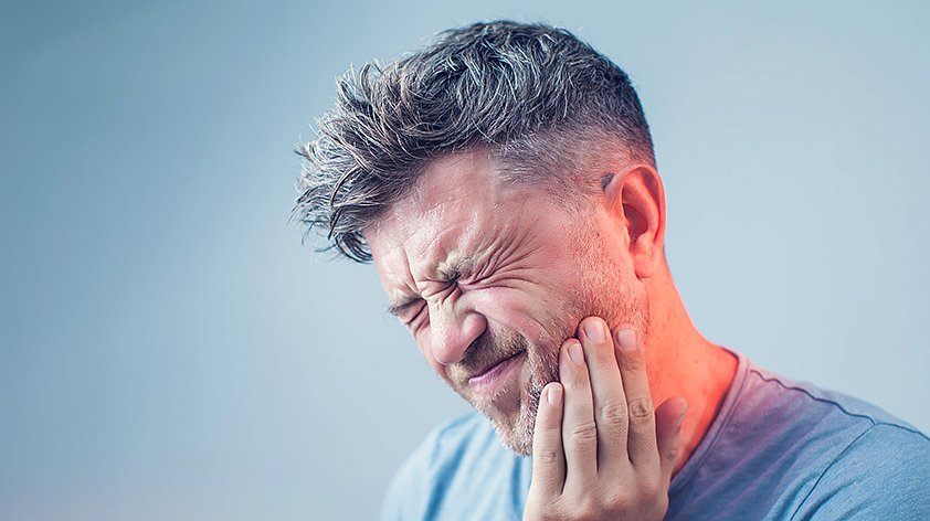 Patient with toothache needing an emergency dentist in Leicester